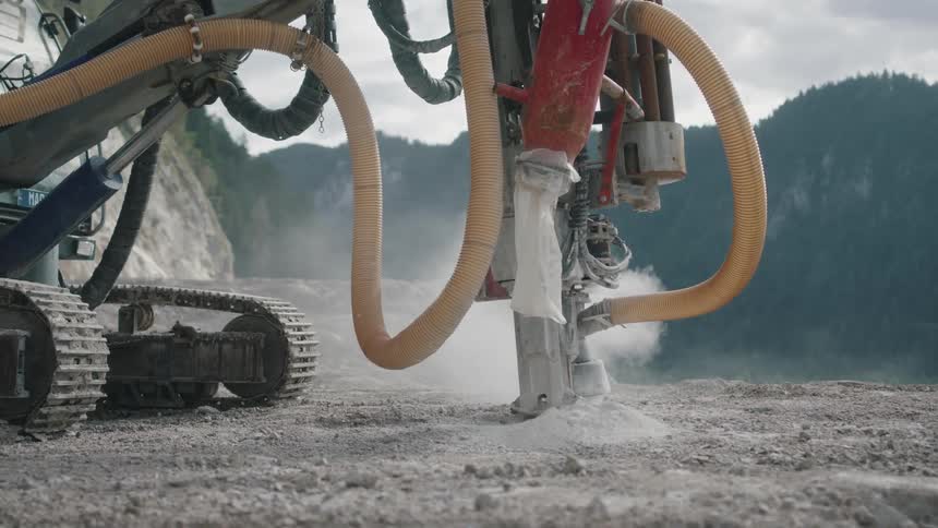 A powerful engine can be seen in action its massive bulk positioned over a patch of ground as it digs into the ground with ease