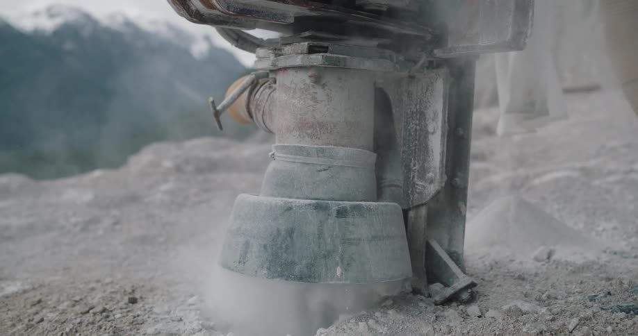 A machine is digging into the rocks
