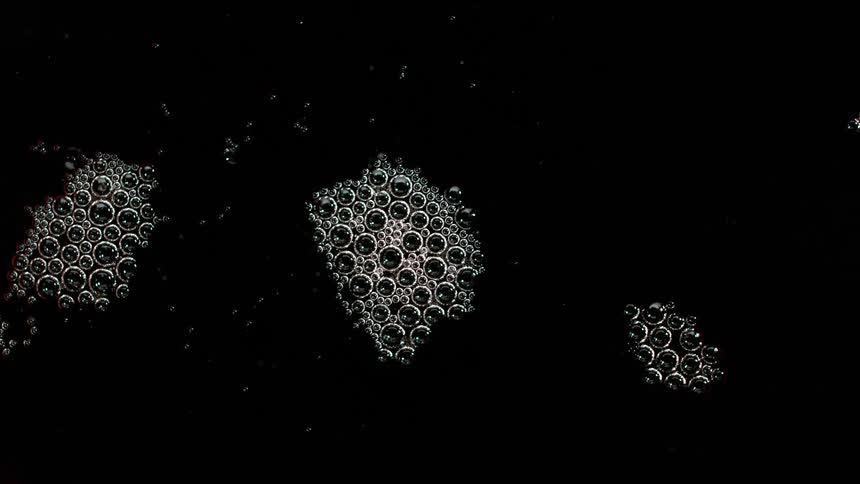 Bubbles on the surface of a black liquid