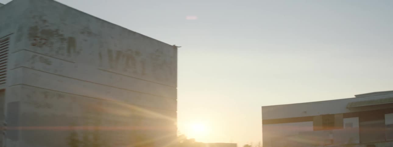 Abandoned buildings seen from a moving vehicle at evening