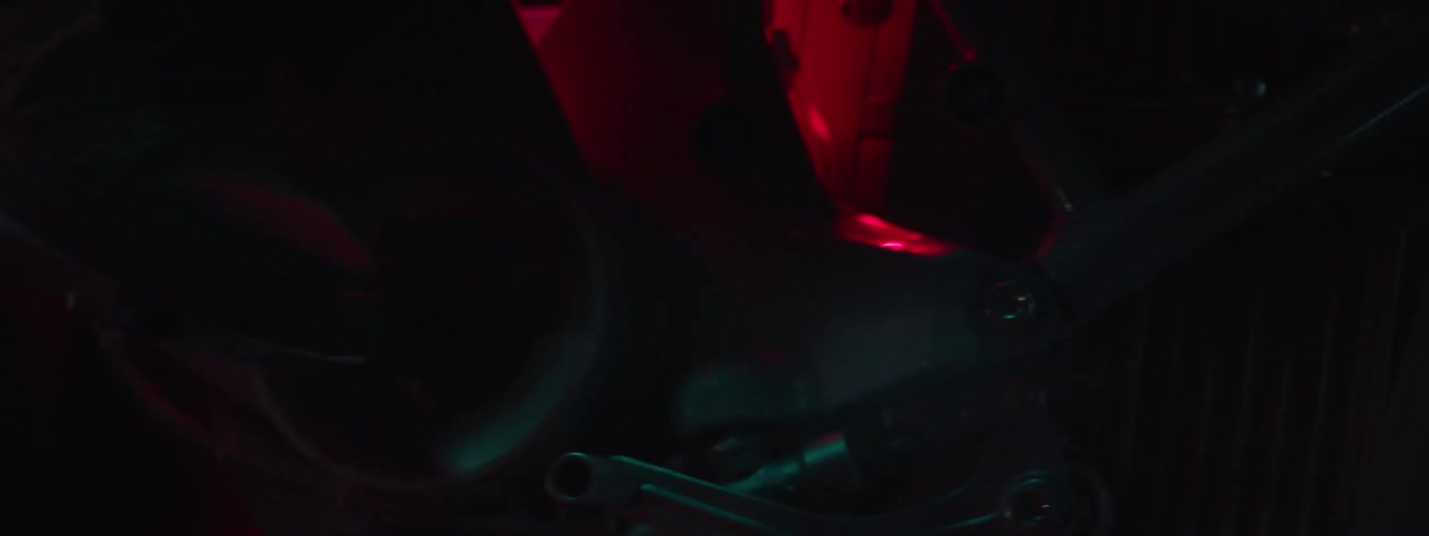 A person working on an engine in the dark