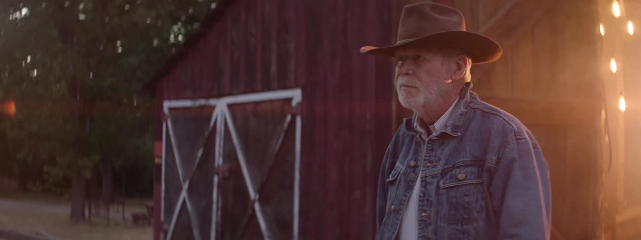 A man exits the smoke filled barn