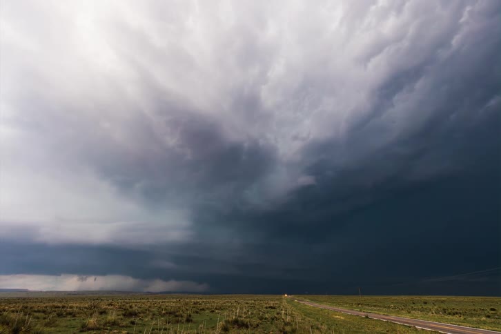 Time lapse view of cars driving through a storm is displayed