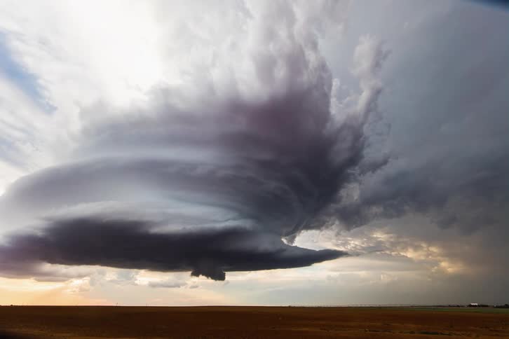 A monster supercell mothership over farm lands