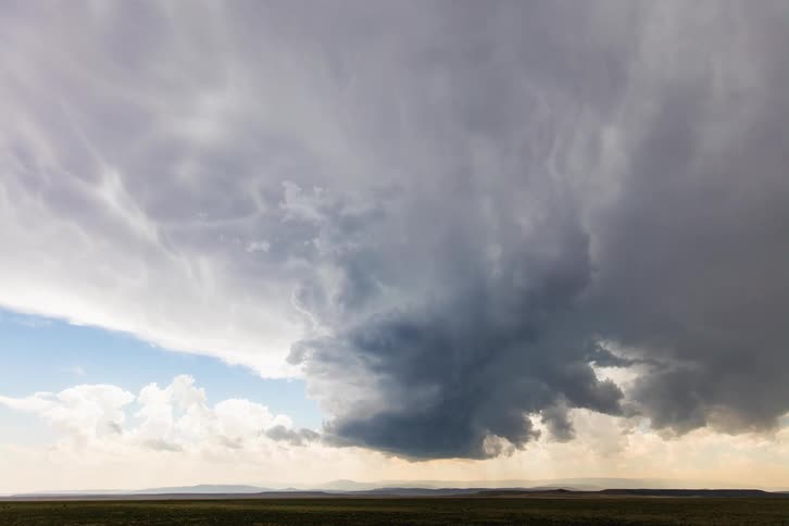 Landscape of dark clouds floating over a field