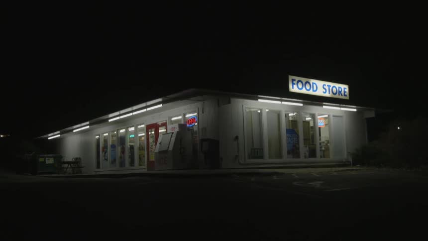 A store is lit on a very dark night