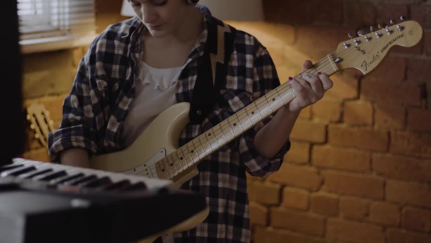 A woman is playing the guitar