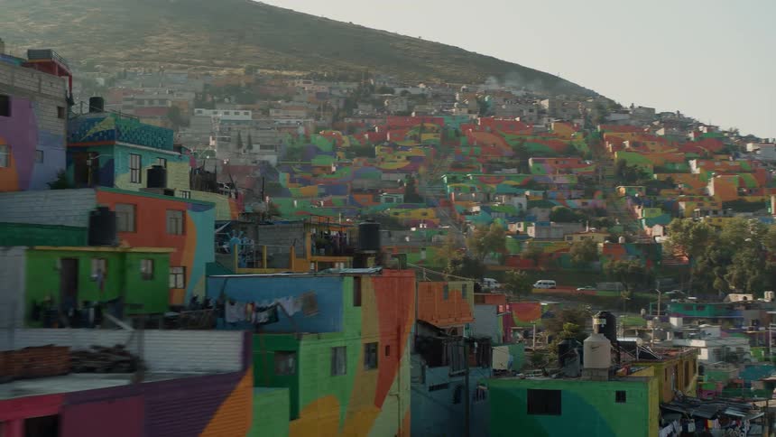 Dense colorful housing covering a hillside in a city