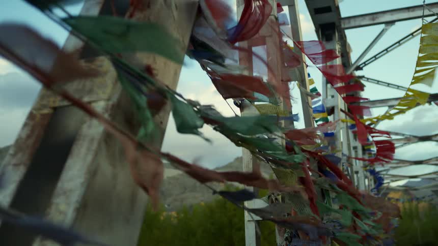 Flags attached to a bridge in the wind