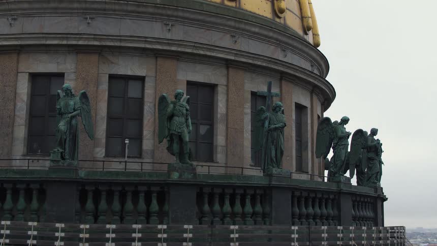 Statues of angels surround the dome of a building