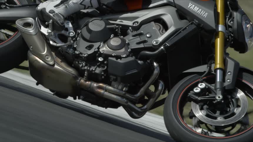 A motorcyclist rides along a curve in the road