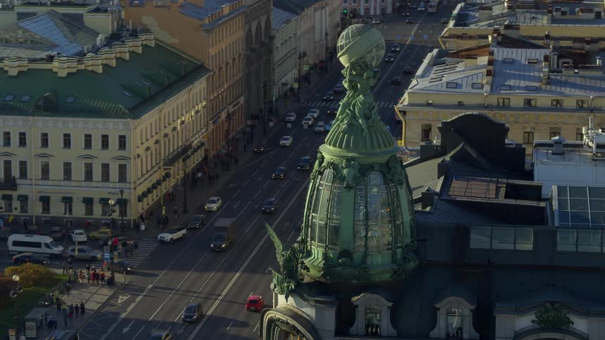 Aerial footage shows a street full of traffic and sidewalks full of countless pedestrians
