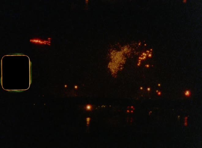 Fireworks lighten up the night sky over a city next to the shoreline
