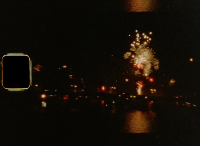 8mm wide shot of fireworks display over the sea at night
