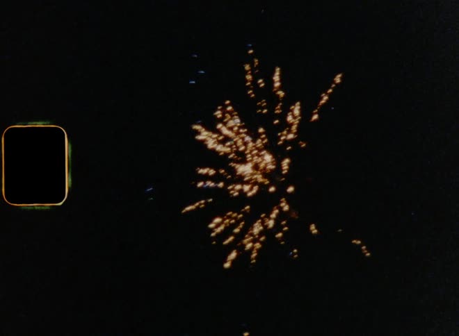 Dynamic handheld film footage of powerful Fireworks exploding in the darkness of the night sky