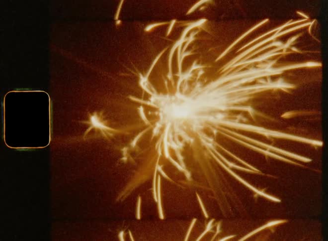 Vintage 8 mm Close up of a firework sparkler sparking and making a flare for a festive celebration