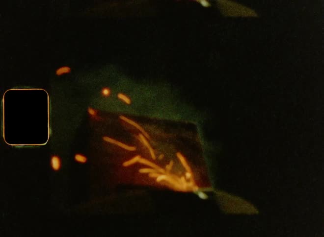 Close up of fuse cord and explosion of a fireworks cracker causing sparks and smoke as a climax