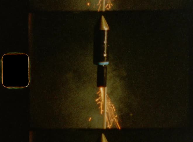 Close up of a hand setting off a fireworks sky rocket with a lighter on New Year’s evening