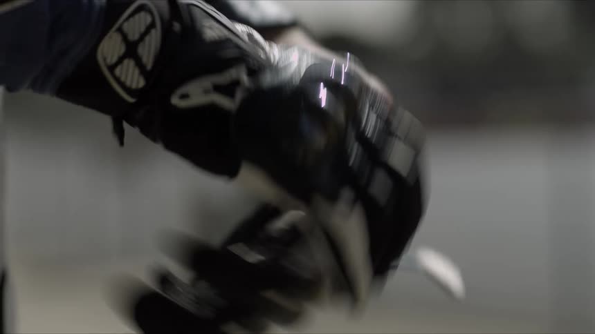 A close up of a person putting riding gloves on their hands