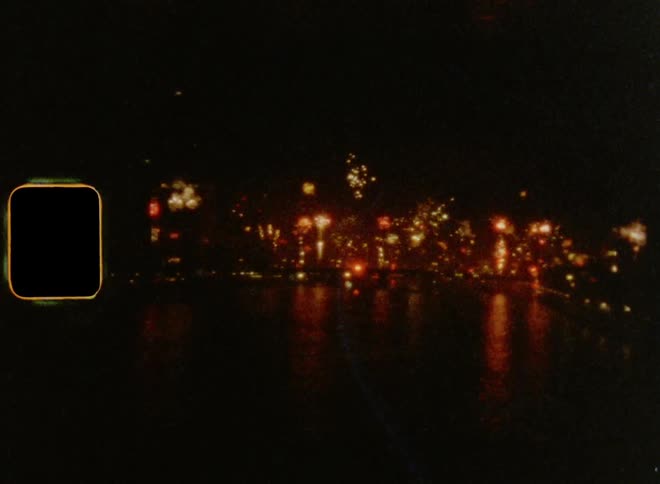 Super 8mm film of a multitude of fireworks and their reflections at the shoreline on New Year’s Eve