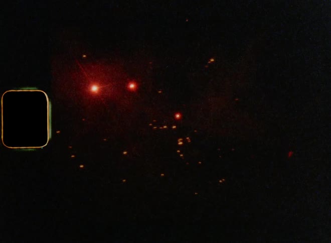 Abstract red sparkles of colorful fireworks in the night sky on 8mm film