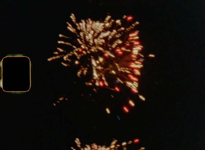 Stunning pyrotechnics sky rockets exploding at night on old Super 8mm film stock with a lot of grain