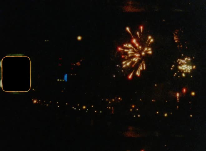 Skyline with fireworks exploding in night sky near waterfront during joyful celebration