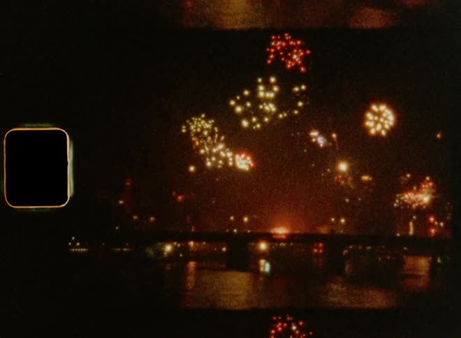Old super 8mm film footage of a fireworks show on New Year’s Evening