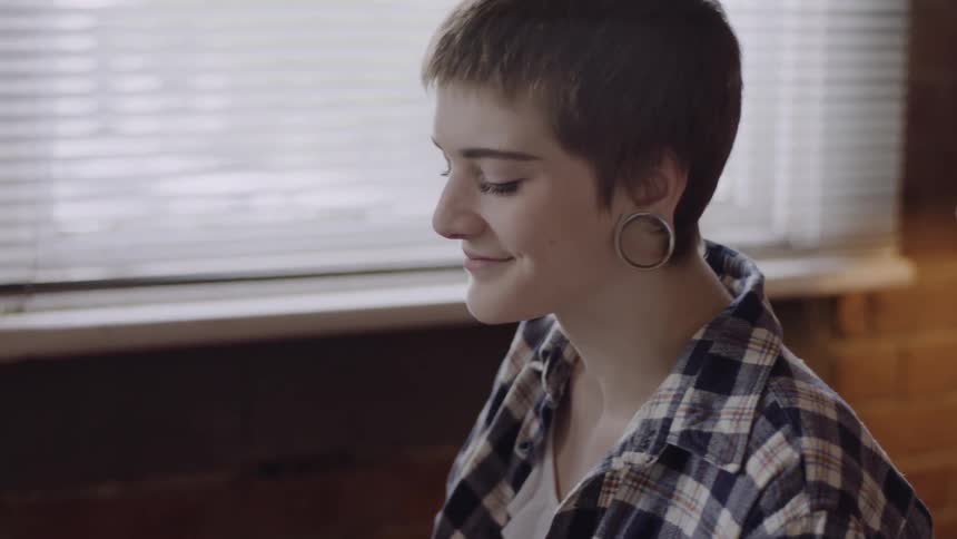 Woman plays the piano and smiles