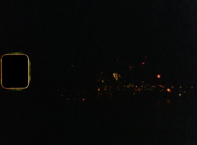July 4th fireworks downtown in a city by the shore on nostalgic 8mm film