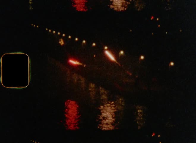 Dynamic fireworks shoot into the darkness of the night as they glow and reflect on the water