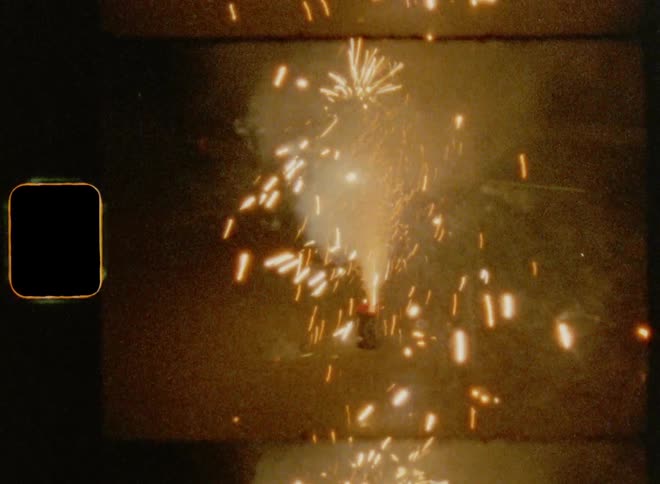 Bright sparkler fireworks going off on the ground during a happy anniversary celebration on Super 8 mm film