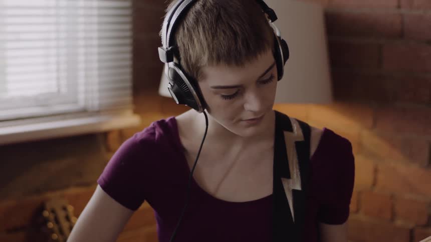 A woman is playing a guitar