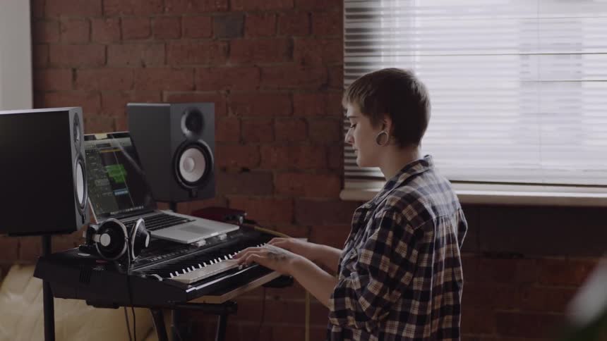 A woman is playing an electronic piano