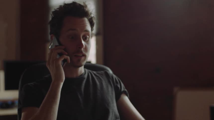 A man answers his phone