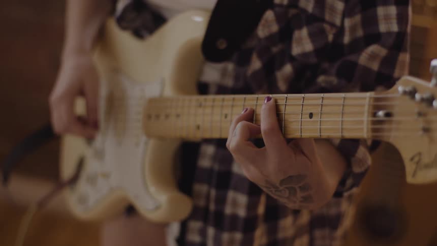A woman playing an electric guitar