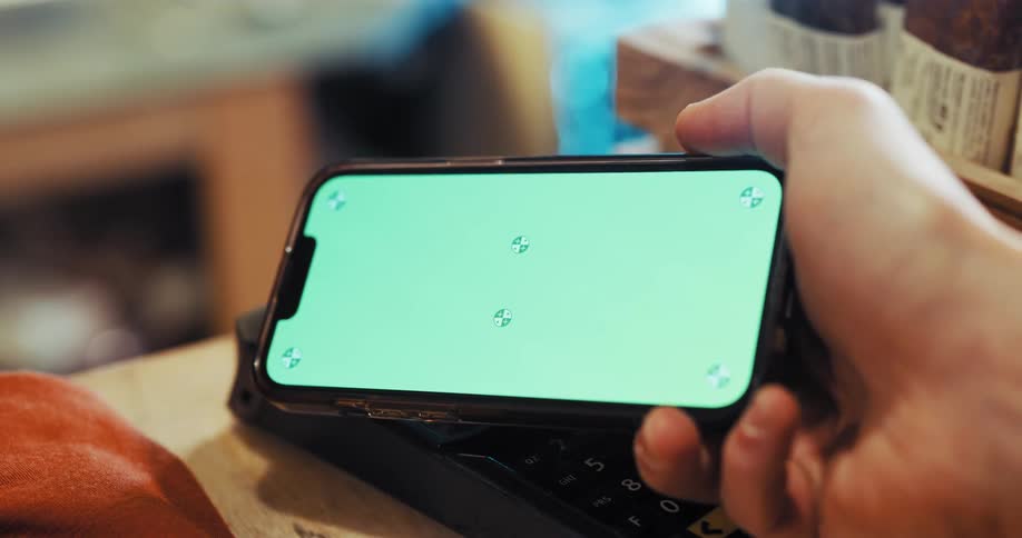 Hand uses phone to pay in store