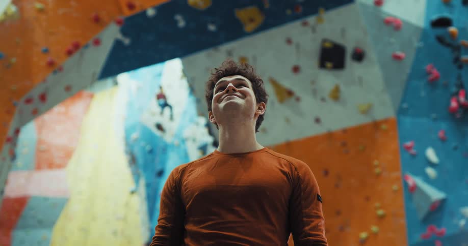 A man standing in a large room looking all around and smiling