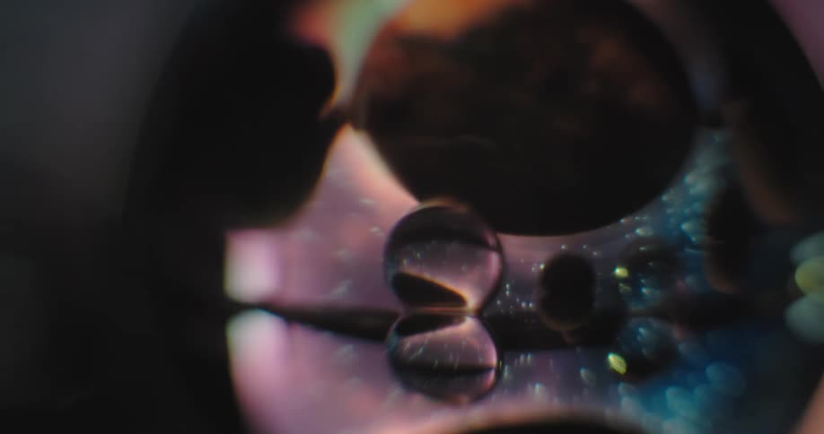 An up close of an abstract piece of art with bubbles and colors inside