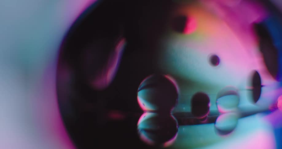 A close up of a colorful sphere with droplets
