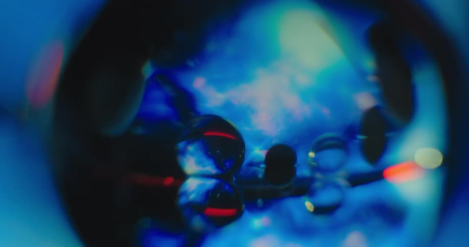 An up close of a blue spherical object with bubbles in it