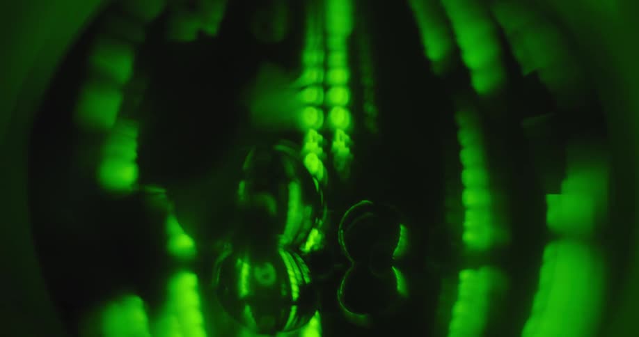 An up close of a green spherical object with numbers appearing vertically