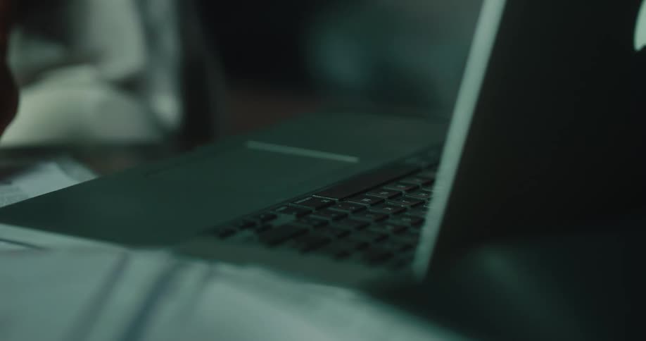 An up close of a persons fingers typing on a laptop keyboard