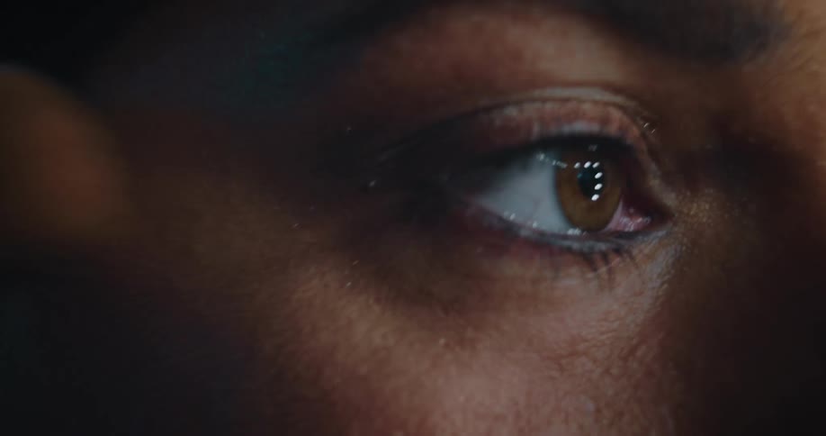 The camera captures a closeup of a womans eye as she applied makeup with a brush