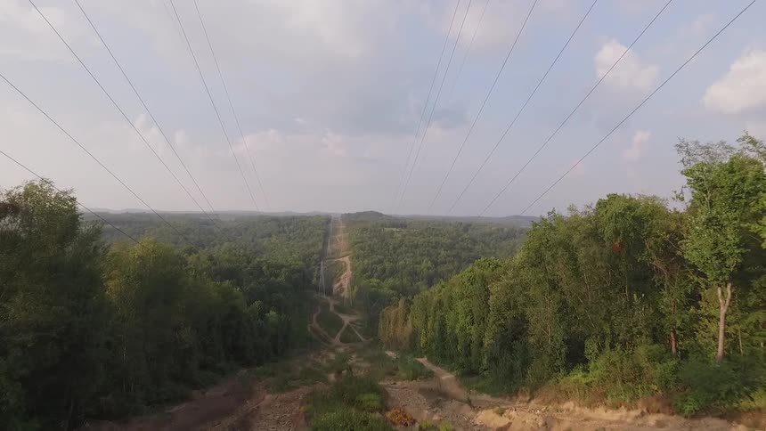 Power lines go into the distance downhill