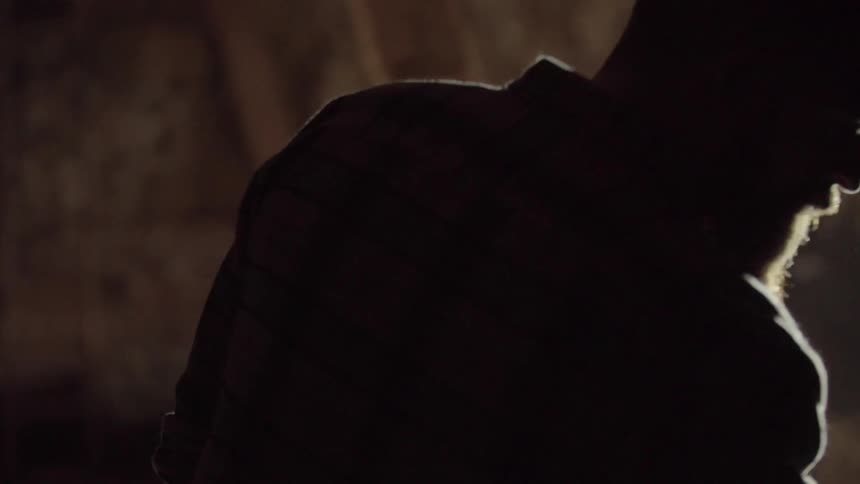 A man walks around a dark room looking around