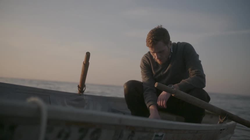 A man sits in a rowboat