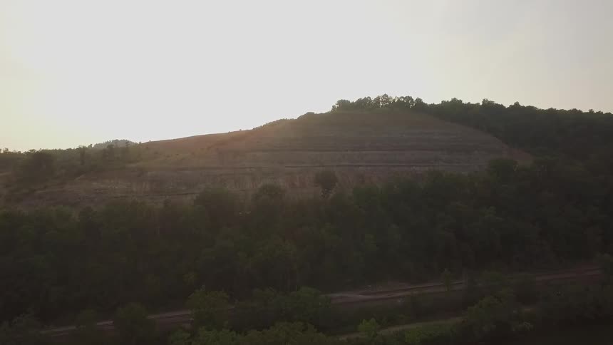 The hills are covered with grass and bushes