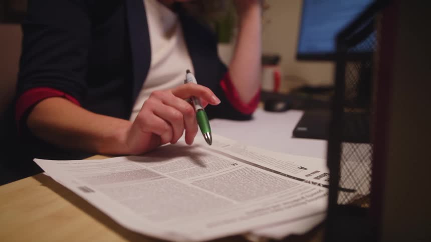 Woman working in office sighs and closes laptop