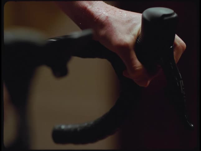 A mans hand is shown pumping something into a bicycle handlebar brake